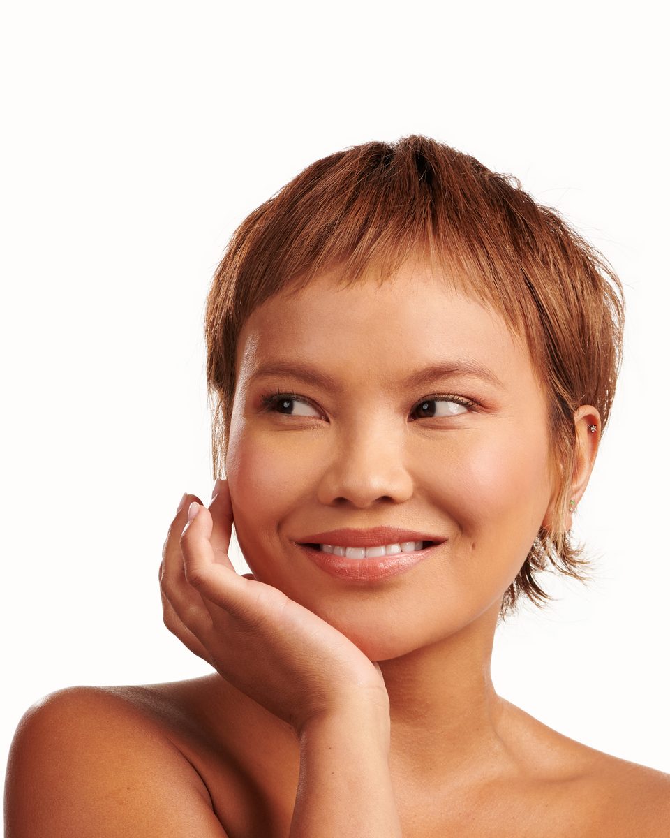 Model smiling with flawless base