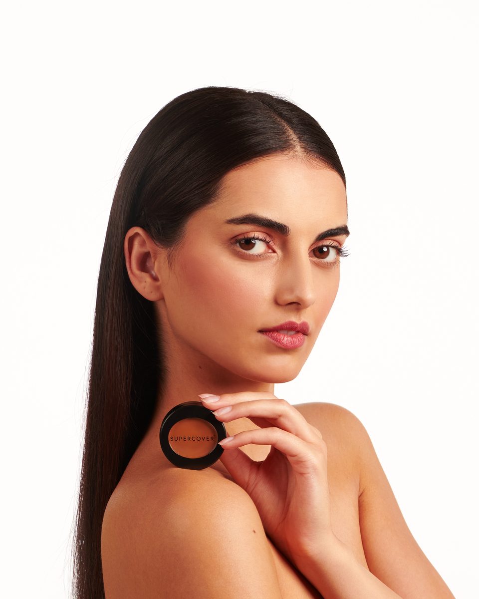 Model holding a SUPERCOVER compact
